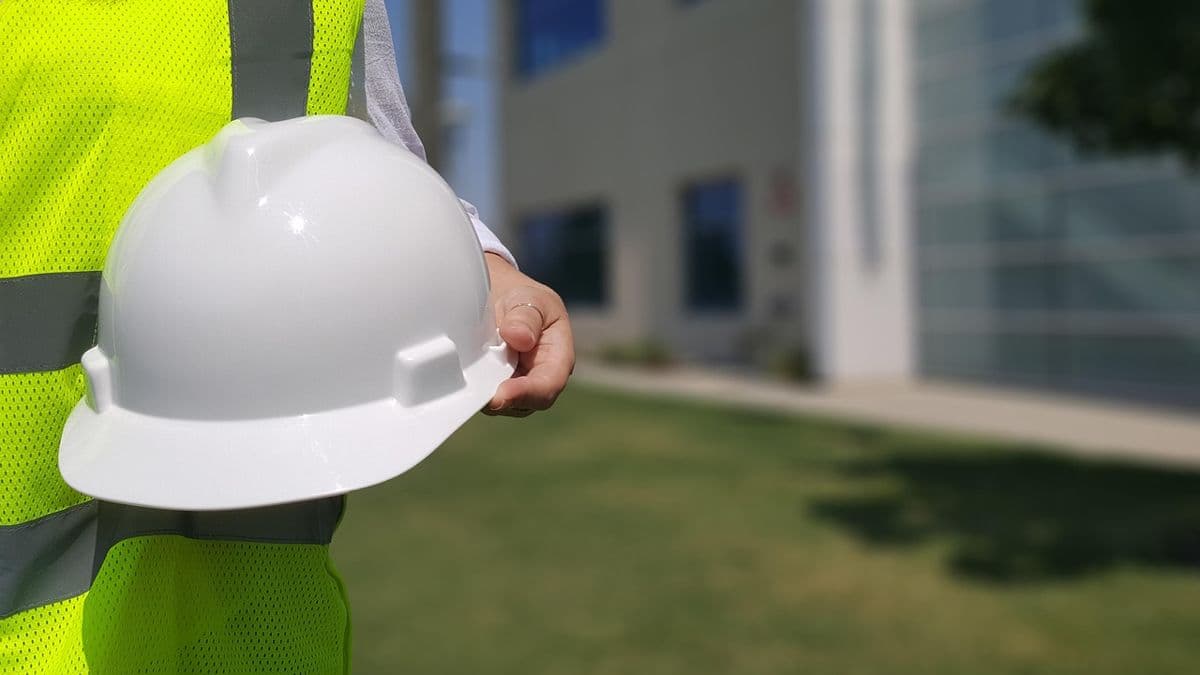 Hard hat and hi-vis vest, labour hire timesheets flowing to payroll and invoicing